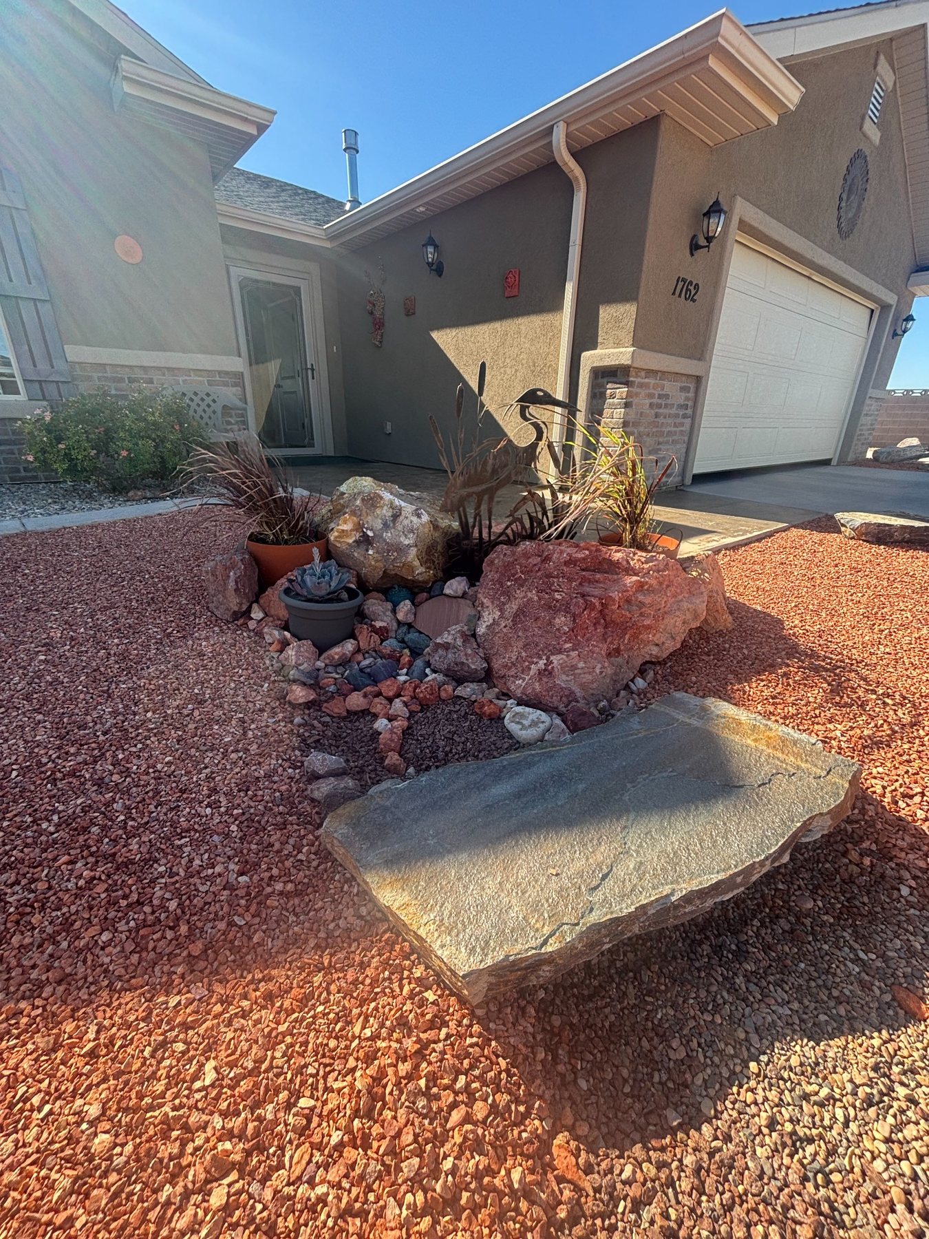 Desert landscaping installation with rock and drought-tolerant plants