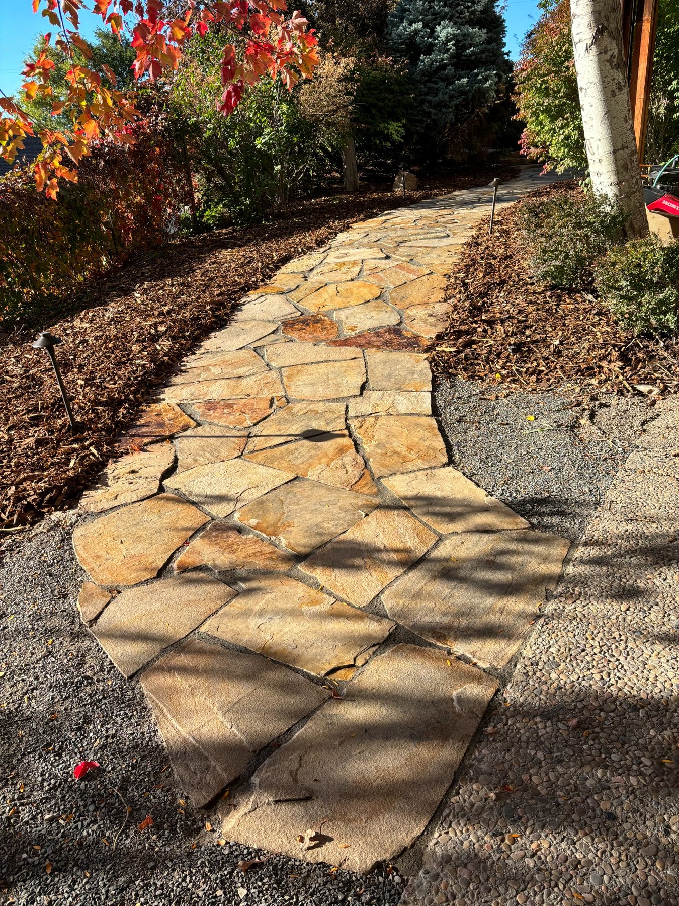 Flagstone walkway through a landscaped yard