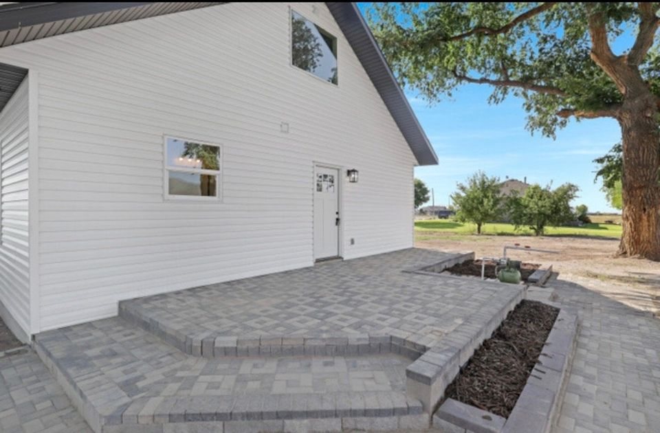 Finished paver patio beside a home